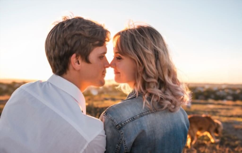 man kissing ladies boobs