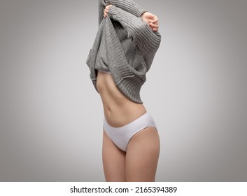 woman taking her clothes off